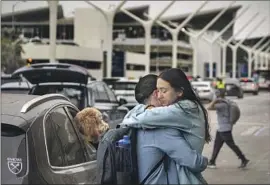  ?? ALLEN J. SCHABEN Los Angeles Times ?? TWO PEOPLE hug outside Los Angeles Internatio­nal Airport in May 2021. Airlines canceled nearly 2,800 flights over the Memorial Day weekend this year.