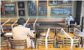  ??  ?? Tables and chairs are taped up to keep social distancing at a Starbucks in Hong Kong, on April 2.