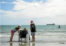  ??  ?? Pippa soaks up the sea air with her two children Caitlin and Connor at Tahunanui Beach.