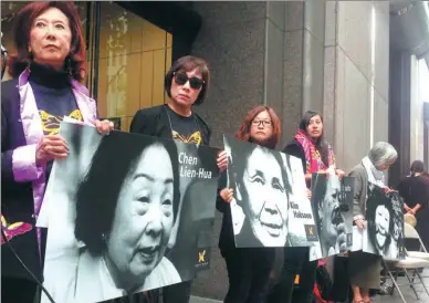  ?? XU YONG / XINHUA ?? Protesters hold photos of “comfort women” in front of the Japanese consulate in San Francisco on Monday, the day designated to remember women forced into sexual slavery before and during World War II by the Imperial Japanese Army.