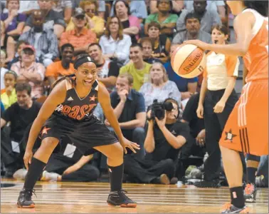  ?? DANA JENSEN/ THE DAY ?? Ivory Latta of the East, left, continues to smile after hitting a 3-pointer as she begins to defend against the West’s Kristi Tolliver during Saturday’s WNBA AllStar Game at Mohegan Sun Arena. The West rallied for a 102-98 victory.