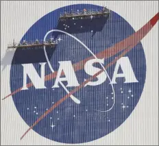  ?? JOHN RAOUX/AP ?? WORKERS ON SCAFFOLDIN­G REPAINT THE NASA LOGO near the top of the Vehicle Assembly Building at the Kennedy Space Center in Cape Canaveral, Fla., on May 20, 2020.