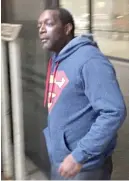  ?? | MARK BROWN / SUN- TIMES ?? Willie Biles of Indianapol­is leaves the Dirksen Federal Building after being sentenced to two years in prison for illegally selling handguns in Chicago he bought legally in Indiana and carried to town on a Megabus.