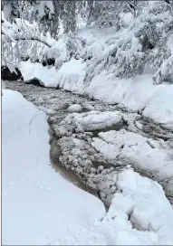  ?? Courtesy photo /Tuolumne Utilities District ?? Snow, slush, and ice backed up last week in the Section 4 Ditch intwain Harte.