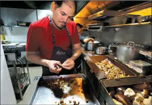  ?? AP/MARCO UGARTE ?? Chef Eduardo Garcia, founder of Maximo Bistrot and former migrant worker in the United States, cuts mushrooms at his restaurant in Mexico City.