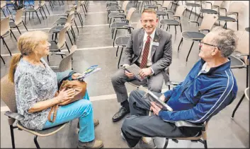  ?? Mark Credico Las Vegas Review-journal ?? Nancy Olds, left, and Richard Pupko, right, talk with Henderson City Council Ward 1 candidate Aaron Johnson on Wednesday at the Heritage Park Senior Facility.