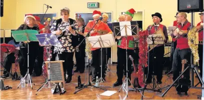  ??  ?? Clitheroe Ukulele Orchestra entertain members of Oswaldtwis­tle and District WI