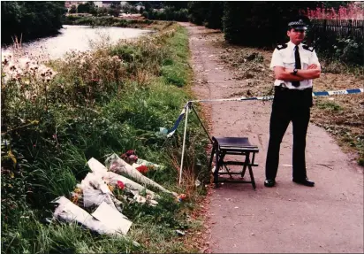  ?? ?? A police officer guards the spot on the banks of the River Leven where the body of Caroline Glachan, 14, was found on August 25, 1996