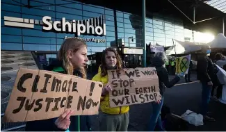  ?? ?? Climate activists protest outside Schiphol Airport in December 2020.