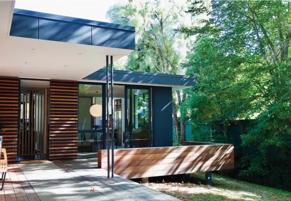  ??  ?? ABOVE Extended to level off the existing home’s ‘L’ shape, the front of the house is clad in dark Titan panels and cedar in a mix of blonde and warmer tones. OPPOSITE The final flourish on the project was the recent landscapin­g of the backyard. “The...