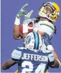  ?? CP ?? Eskimos wide receiver Derel Walker makes a touchdown pass in front of Argonauts defensive back A.J Jefferson during the first half of their game in Toronto on Saturday.