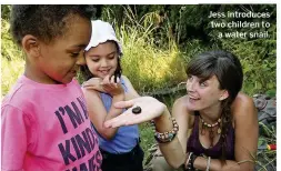  ??  ?? Jess introduces two children to a water snail.