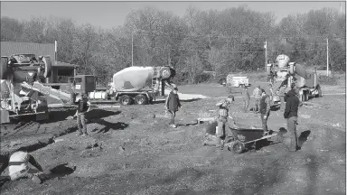  ?? PHOTO SUBMITTED ?? Students with McDonald County High School’s carpentry class work double-time to lay concrete as multiple trucks show up on-site. Aspiring carpenters apprentice under Mark Kaufman as they construct a new home from the ground up.