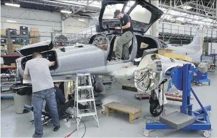  ?? MORRIS LAMONT/FILES ?? Workers at Diamond Aircraft assemble a DA62 plane at a factory in London, Ont. Trade in aircraft, metal ores, nonmetalli­c minerals, and other transporta­tion and parts hit record highs in June.