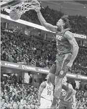  ?? Jason Miller Getty Images ?? DeANDRE JORDAN dunks during the first half against the Cavaliers. Cleveland won in overtime.