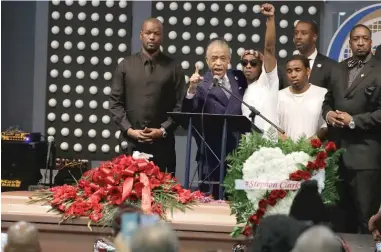  ?? JEFF CHIU, POOL/ AP ?? The Rev. Al Sharpton speaks to Stevante Clark ( arm raised) during the funeral services for Clark’s brother, Stephon Clark, who was shot and killed by Sacramento police on March 18.