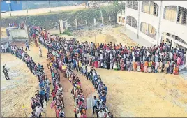  ?? PTI PHOTO ?? People queue up to cast votes for at a polling booth in Agartala on Sunday.