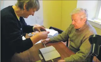  ?? Photograph: Friends of the Argyll Papers. ?? Ronnie Black and his wife Máire hard at work digitally photograph­ing the Dewar Manuscript­s.