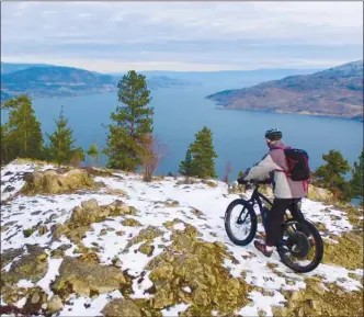  ?? PHOTO CONTRIBUTE­D/ET2media ?? A mountain biker enjoys the view from atop the Fur Brigade Trail between Summerland and Peachland west of Highway 97.