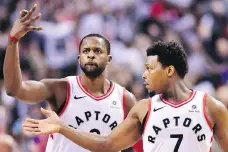  ?? FRANK GUNN/THE CANADIAN PRESS ?? Toronto Raptors forward C.J. Miles, left, and guard Kyle Lowry celebrate a basket against the Washington Wizards during the second half of Saturday’s playoff game in Toronto.