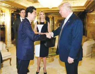  ??  ?? NEW YORK: This handout picture, released by Japan’s Cabinet Secretaria­t yesterday shows Japanese Prime Minister Shinzo Abe (2nd L) being welcomed by US President-elect Donald Trump (R) beside Ivanka Trump (C) and her husband Jared Kushner (L).—AFP