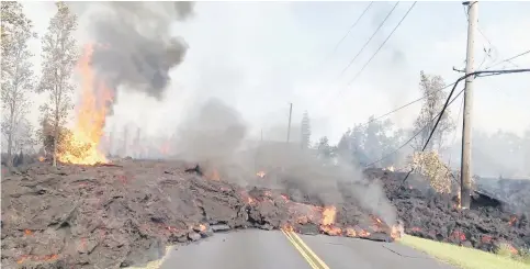  ?? — Reuters photo ?? Lava advances along a street near a fissure in Leilani Estates, on Kilauea Volcano’s lower East Rift Zone.