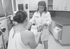  ?? LYNNE SLADKY, AP ?? Nurse practition­er Juliana Duque gives a pregnant patient insecticid­e and mosquito protection informatio­n in Miami.