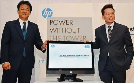  ??  ?? ALL-IN-ONE: Kim (left) and Hewlett-packard Singapore (Sales) Pte Ltd personal systems group vice-president and general manager for South Asia and Taiwan Dennis Mark introducin­g the Z1 workstatio­n.