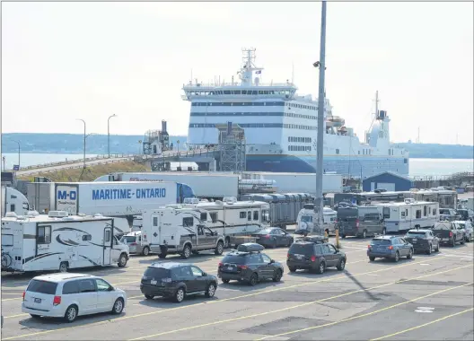  ?? JEREMY FRASER/CAPE BRETON POST ?? Passenger and commercial traffic line up at the Marine Atlantic terminal in North Sydney to board the MV Highlander­s for a crossing between North Sydney and Port aux Basques, Aug. 7.