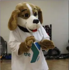  ?? MICHILEA PATTERSON — FOR DIGITAL FIRST MEDIA ?? Pottstown YMCA Aquatics Supervisor Aimee Gilbert dances during a family Zumba demonstrat­ion class while wearing the “Y-Doh the Y Dog” mascot uniform during the wellness center’s reopening.