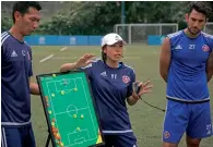  ?? AFP ?? Eastern coach Chan Yuen-ting (centre) talks to her players during a team training session in Hong Kong. —