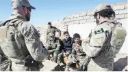  ?? RYAN REMIORZ / THE CANADIAN PRESS FILES ?? Canadian special forces soldiers speak with Kurdish fighters in 2017 in northern Iraq. Up to 250 Canadian troops will be part of a new NATO mission in Iraq.