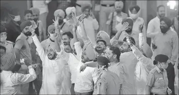  ?? KESHAV SINGH/HT ?? Supporters of Charanjit Singh Channi celebrate outside Punjab Raj Bhawan on Sunday.