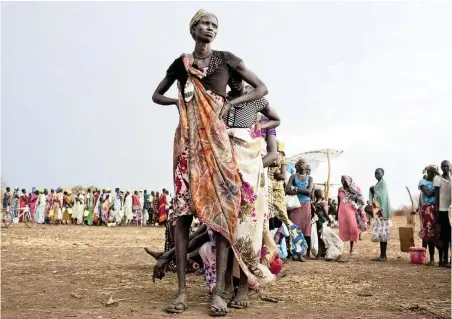  ?? PICTURE: REUTERS ?? QUEUEING FOR BASIC RIGHTS: Women and children displaced by recent fighting between rebel soldiers and government troops wait to collect their food rations in South Sudan’s Mingkaman refugee camp in this file picture.