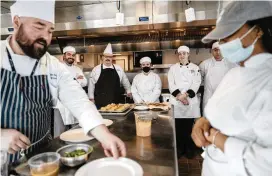  ?? KIERAN KESNER / THE NEW YORK TIMES ?? A culinary program class at Northern Essex Community College in Haverhill, Mass. As culinary programs dwindle and restaurant­s hunt for help, some local campuses are adding state-of-the-art cooking schools.