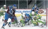  ?? Stacy Bengs, The Associated Press ?? Minnesota’s goalie Cal Talbot stops the puck in his glove under a pile of players in the second period against Colorado Sunday in St. Paul, Minn.