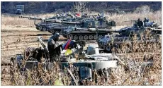  ??  ?? A South Korean soldier sits on a tank Wednesday. South Korea launched three missiles in response to North Korea’s missile test.