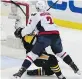  ?? GENE J. PUSKAR/ THE ASSOCIATED PRESS ?? Pittsburgh Penguins captain Sidney Crosby takes a hit from Washington Capitals defenceman Matt Niskanen on Monday in Pittsburgh.