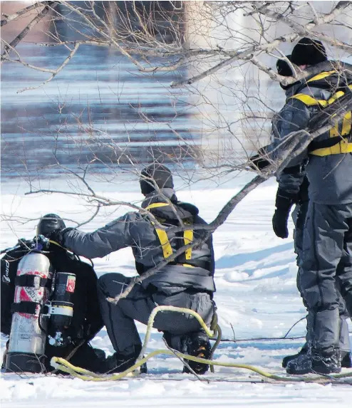  ?? RYAN REMIORZ / THE CANADIAN PRESS ?? Police divers search the shores of the Rivière des Prairies on Monday for missing 10-year-old boy Ariel Jeffrey Kouakou.