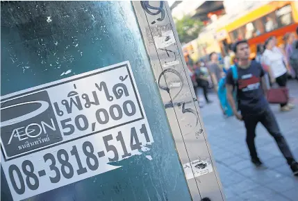  ?? PATTARAPON­G CHATPATTAR­ASIL ?? A leaflet advertisin­g quick loans is seen in Bangkok street. P2P lending has the potential to address the loan shark problem in Thailand.