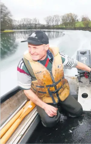  ??  ?? Eel fisherman Michael Holmes zips down the Waikato River to check on his