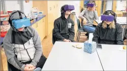  ?? AP PHOTO ?? Students at the Berkeley Carroll School in the Brooklyn borough of New York use virtual reality headsets in their classroom.