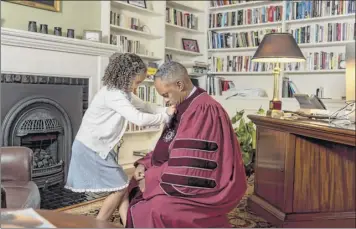  ?? Shawn Lachapelle / union College ?? maya Harris helps her father, union College President david Harris, get ready before his inaugurati­on ceremony Saturday at the school campus in Schenectad­y.