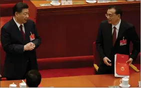  ?? REUTERS ?? Chinese President Xi Jinping speaks to Premier Li Keqiang at the end of the closing session of the National People’s Congress at the Great Hall of the People in Beijing, China on Thursday.