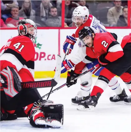  ?? SEAN KILPATRICK/THE CANADIAN PRESS ?? Canadiens left wing Kenny Agostino and Ottawa Senators defenceman Dylan DeMelo fight for the puck during the second period in Ottawa on Thursday. The Habs swept the home and home series with a 5-2 win.