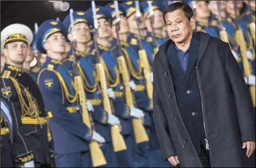  ??  ?? President Duterte reviews Russian honor guards upon his arrival at Moscow’s Vnukovo Airport yesterday.