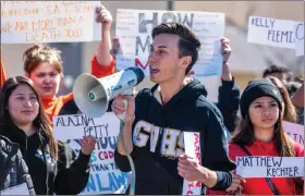  ?? Austin Dave/The Signal ?? Student Dean Douglas leads his peers in chants as they hold signs displaying the handwritte­n names of school shooting victims during a demonstrat­ion at Golden Valley High on Wednesday.