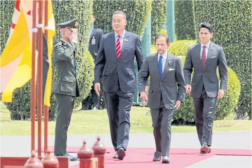  ?? CHANAT KATANYU ?? His Majesty Sultan Haji Hassanal Bolkiah of Brunei, front right, followed behind by His Royal Highness Prince Abdul Mateen, is accompanie­d by Prime Minister Srettha Thavisin in reviewing a guard of honour at Government House. The Sultan made an official visit at Mr Srettha’s invitation over the weekend. One of the highlights of the trip is a bilateral commitment towards collaborat­ive growth and economic advancemen­t.