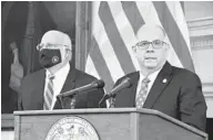  ?? PAMELA WOOD/BALTIMORE SUN ?? Gov. Larry Hogan, with new advisor Robert R. Redfield in the background, announced Tuesday that he is lifting capacity limits at restaurant­s and opening up large indoor and outdoor venues at 50% capacity, while keeping in effect the state’s mask mandate.