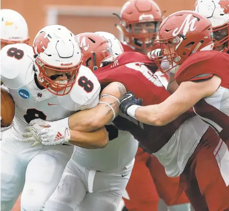  ?? DAVID GARRETT/SPECIAL TO THE MORNING CALL ?? Muhlenberg’s Kwasi Ampomah tackles North Central running back Ethan Greenfield during Saturday’s Division III semifinal game.